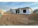 New home under construction with unlandscaped backyard at 22708 E Lords Way, Queen Creek, AZ 85142