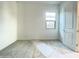 Spacious bedroom with gray carpet, a window, and white walls at 22717 E Saddle Way, Queen Creek, AZ 85142