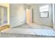 Bright bedroom with gray carpet, a window, and white walls at 22717 E Saddle Way, Queen Creek, AZ 85142