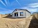 New home backyard with fresh dirt ready for landscaping, featuring a neutral wall and covered patio at 22740 E Lords Way, Queen Creek, AZ 85142