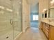 Bathroom featuring walk-in shower, double sink vanity, and tile flooring with an open view of a room beyond at 22740 E Lords Way, Queen Creek, AZ 85142