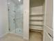 Modern bathroom featuring a glass enclosed shower with white subway tile and a storage closet with shelving at 22740 E Lords Way, Queen Creek, AZ 85142