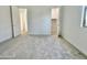 Carpeted bedroom featuring closet, entry door, and window, and a door to the bathroom at 22740 E Lords Way, Queen Creek, AZ 85142