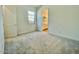 Bright bedroom with neutral carpet, bathroom access, and natural light from a well-sized window at 22740 E Lords Way, Queen Creek, AZ 85142