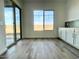 Bright dining room with tile flooring, a large window, and white cabinets at 22740 E Lords Way, Queen Creek, AZ 85142