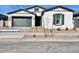 Charming single-story home featuring a gray garage door, white exterior paint, and a desert-landscaped yard at 22740 E Lords Way, Queen Creek, AZ 85142