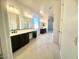 Double vanity bathroom with dark cabinets and a walk-in shower at 22910 E Alyssa Rd, Queen Creek, AZ 85142