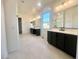 Spa-like bathroom with double vanity, dark cabinets, and natural light at 22910 E Alyssa Rd, Queen Creek, AZ 85142