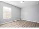 Well-lit bedroom with wood-look floors and a window at 2355 N Oakmont Ln, Casa Grande, AZ 85122