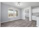 Bright dining room with gray walls, wood-look floors, and access to the kitchen at 2355 N Oakmont Ln, Casa Grande, AZ 85122