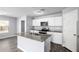 Modern kitchen with white cabinets, granite countertops, island, and stainless steel appliances at 2355 N Oakmont Ln, Casa Grande, AZ 85122