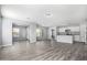 Open concept living room and kitchen with gray walls and wood-look floors at 2355 N Oakmont Ln, Casa Grande, AZ 85122