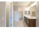 Spacious bathroom with double sinks, modern lighting, and a glass-enclosed shower at 24153 W Hilton Ave, Buckeye, AZ 85326