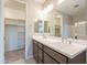 Large bathroom vanity featuring double sinks and a view of a walk-in closet at 24153 W Hilton Ave, Buckeye, AZ 85326