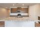 Modern kitchen with granite countertops, stainless steel appliances, and dark wood cabinets at 24153 W Hilton Ave, Buckeye, AZ 85326