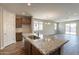 Beautiful kitchen island with granite countertops and a stainless steel sink, perfect for entertaining guests at 24153 W Hilton Ave, Buckeye, AZ 85326