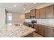 Contemporary kitchen with granite countertops, stainless steel appliances, and dark wood cabinetry at 24153 W Hilton Ave, Buckeye, AZ 85326