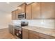 Modern kitchen with stainless steel appliances, granite countertops, and stylish backsplash at 24153 W Hilton Ave, Buckeye, AZ 85326