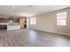Bright and airy living space with large windows and recessed lighting, showcasing the hardwood flooring at 24153 W Hilton Ave, Buckeye, AZ 85326