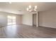 Open-concept living room with hardwood floors, sliding glass doors, and recessed lighting fixtures at 24153 W Hilton Ave, Buckeye, AZ 85326