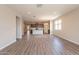 Spacious open-concept living area with hardwood floors leading into the kitchen and dining area at 24153 W Hilton Ave, Buckeye, AZ 85326