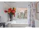 Relaxing bathroom with soaking tub and window at 25227 S Mohawk Dr, Sun Lakes, AZ 85248