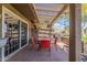 Patio with red table and chairs under pergola at 25227 S Mohawk Dr, Sun Lakes, AZ 85248