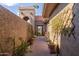 Landscaped walkway with lush greenery and decorative pots at 25227 S Mohawk Dr, Sun Lakes, AZ 85248