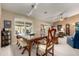 Formal dining room with wood table and chairs, and large windows at 25432 S Queen Palm Dr, Sun Lakes, AZ 85248