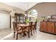 Bright dining room with wood table and chairs, near kitchen at 25432 S Queen Palm Dr, Sun Lakes, AZ 85248