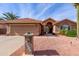 Tan house with tile roof, garage, and landscaped yard at 25432 S Queen Palm Dr, Sun Lakes, AZ 85248