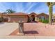 Tan house with tile roof, garage, and landscaped yard at 25432 S Queen Palm Dr, Sun Lakes, AZ 85248