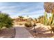 Landscaped front yard with a walkway, cacti, and bird bath at 25432 S Queen Palm Dr, Sun Lakes, AZ 85248