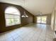 Spacious living room with arched window and slider to the patio at 25432 S Queen Palm Dr, Sun Lakes, AZ 85248