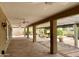 Large covered patio with stamped concrete, ceiling fans and desert landscaping at 25432 S Queen Palm Dr, Sun Lakes, AZ 85248