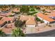 Aerial view of the home with a three-car garage with golf course views and desert landscaping at 25440 S Flame Tree Dr, Sun Lakes, AZ 85248