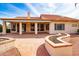 An open backyard with a covered patio that offers ample space for entertaining at 25440 S Flame Tree Dr, Sun Lakes, AZ 85248