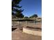 A view of the golf course from the backyard with a white fence and brick patio at 25440 S Flame Tree Dr, Sun Lakes, AZ 85248