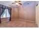 Bedroom with neutral walls, carpeting, ceiling fan, and a window with decorative curtains at 25440 S Flame Tree Dr, Sun Lakes, AZ 85248