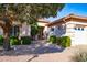 Inviting home entrance with manicured landscaping, desert rock and mature trees at 25440 S Flame Tree Dr, Sun Lakes, AZ 85248