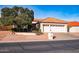 Charming single-story home featuring a terracotta roof and a well-manicured front yard with mature trees at 25440 S Flame Tree Dr, Sun Lakes, AZ 85248