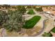 Aerial view of the verdant golf course with trees and sand traps in a community at 25440 S Flame Tree Dr, Sun Lakes, AZ 85248