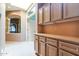 Hallway showing custom wood cabinets and a decorative transom window above an entry door at 25440 S Flame Tree Dr, Sun Lakes, AZ 85248