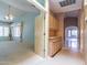 Hallway entrance showcases a living room and a cabineted hallway nook, connected by tile and carpet floors at 25440 S Flame Tree Dr, Sun Lakes, AZ 85248