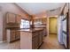 Bright kitchen features an island, granite countertops and modern appliances at 25440 S Flame Tree Dr, Sun Lakes, AZ 85248