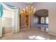 Living room showcasing arched doorways, neutral walls, a chandelier, and an adjacent living space at 25440 S Flame Tree Dr, Sun Lakes, AZ 85248