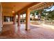 An expansive covered patio with red tile flooring offers a great outdoor living space at 25440 S Flame Tree Dr, Sun Lakes, AZ 85248