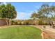 Landscaped backyard with circular artificial turf and patio furniture at 25802 N Hackberry Dr, Phoenix, AZ 85083