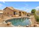 Relaxing kidney-shaped pool surrounded by rocks and a patio at 25802 N Hackberry Dr, Phoenix, AZ 85083