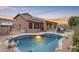 Inviting kidney-shaped pool with rock landscaping, patio furniture, and mountain views at 25802 N Hackberry Dr, Phoenix, AZ 85083